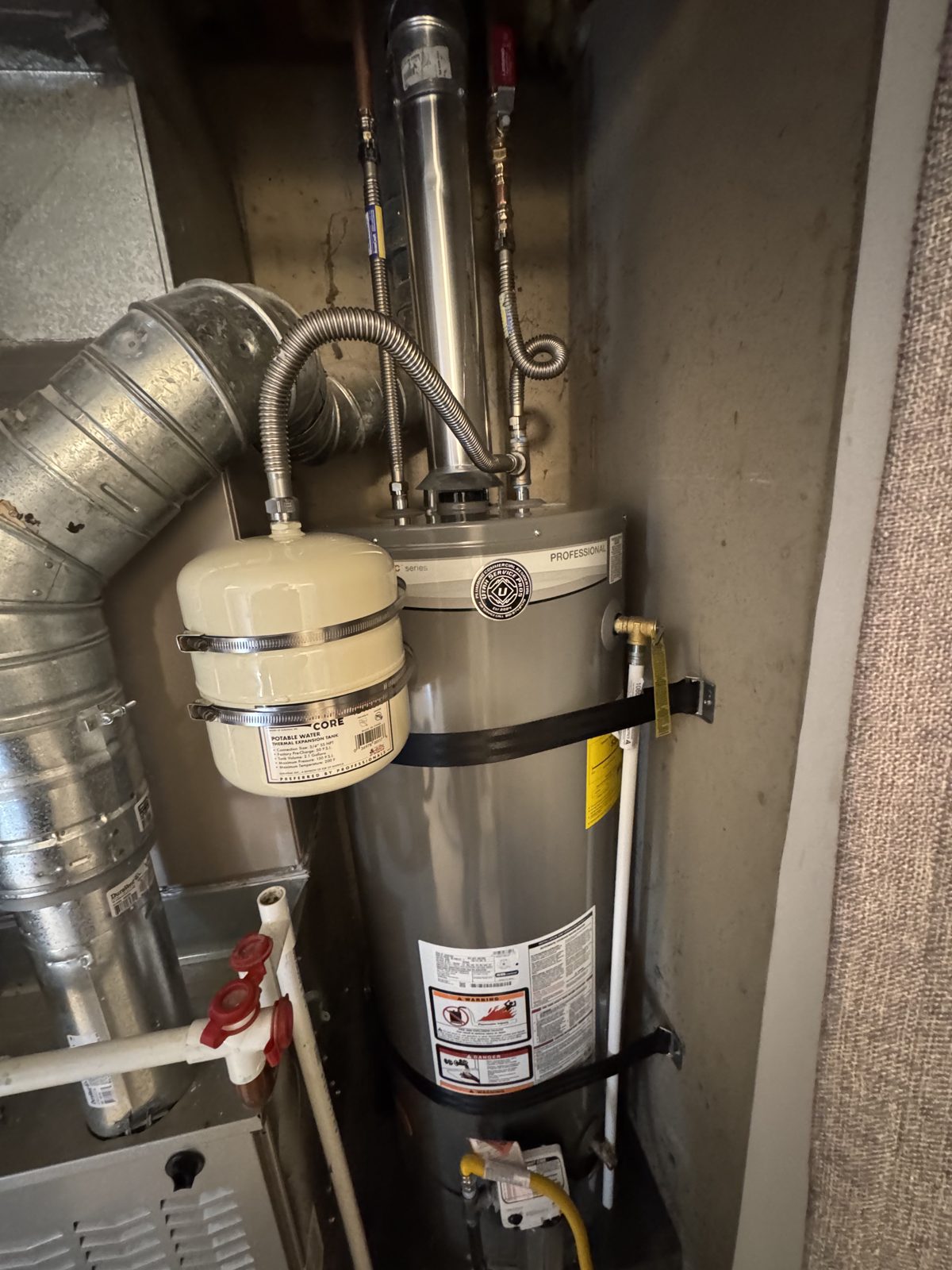 New gas water heater with thermal expansion tank and venting installed to code