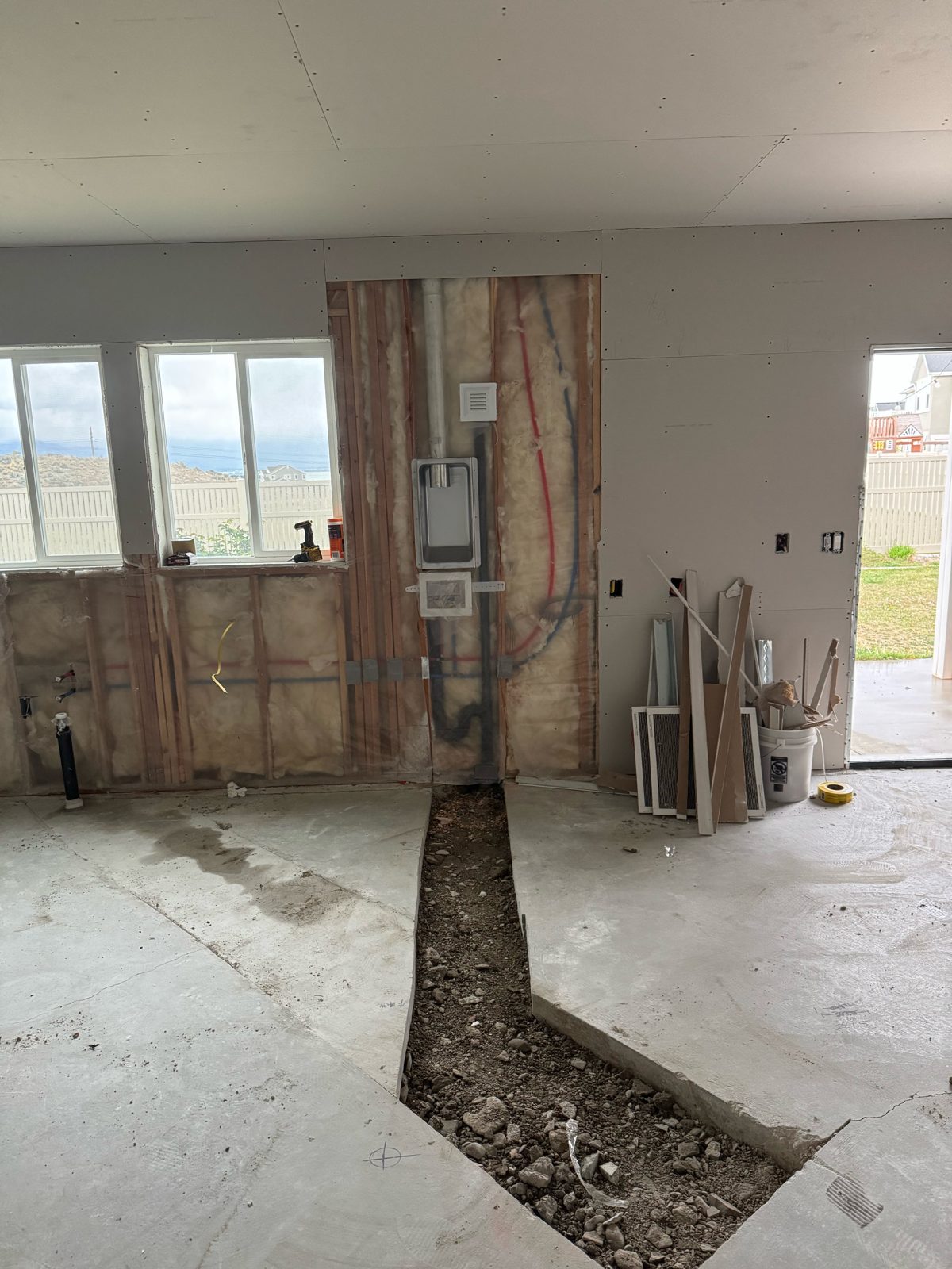 Slab trench for relocated kitchen plumbing during a remodel