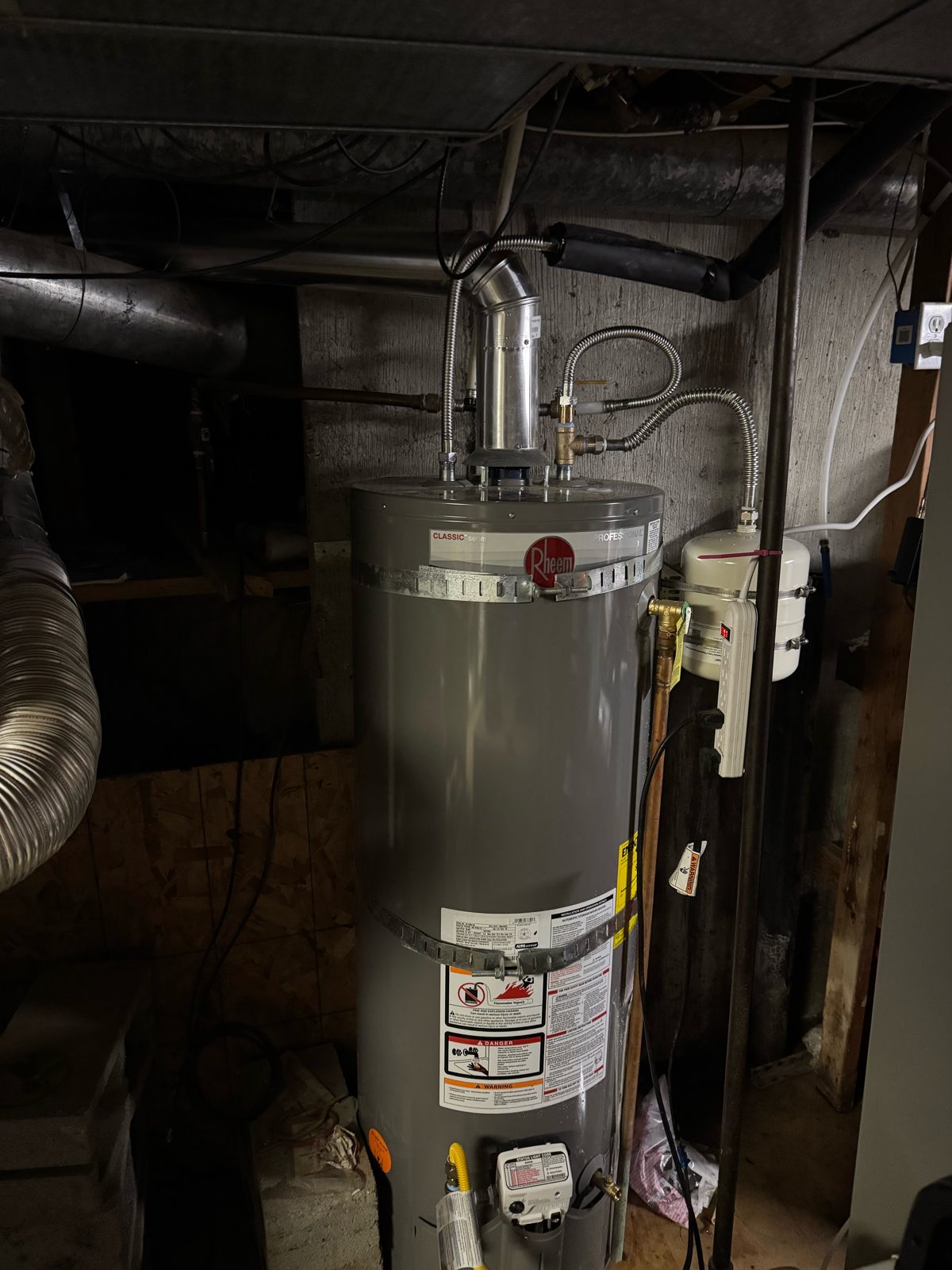 Aging water heater in a basement before replacement