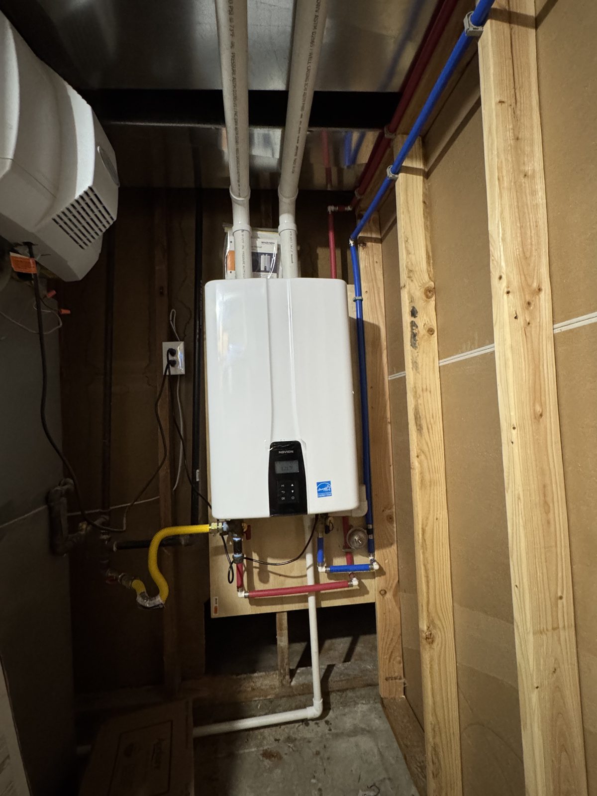 Tankless water heater installed during new construction framing